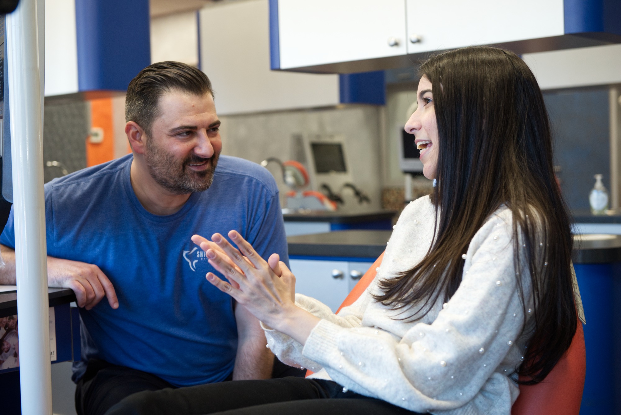 Northport orthodontics consultation conversation Two people talking in an orthodontic exam room